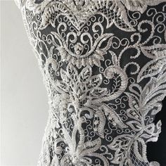 the back of a dress with white lace on it