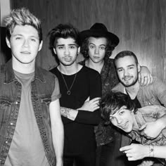 the band one direction posing for a black and white photo