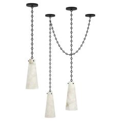 three light chandelier with white marble and black metal chains hanging from the ceiling