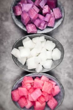 three bowls filled with diced up vegetables on top of a gray countertop next to each other