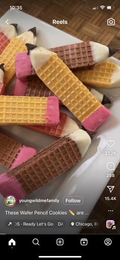 some waffles are sitting on a plate with pink and yellow icing in them