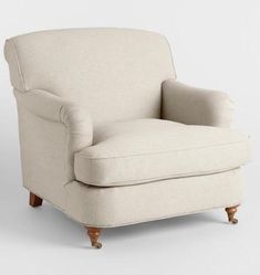 an upholstered chair with wooden legs on a white background