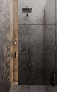 a walk in shower sitting inside of a bathroom next to a tiled wall and floor