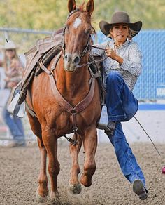 a man riding on the back of a brown horse