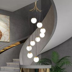 an elegant staircase with chandelier and art work on the wall