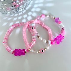 These 3 styles of pink bracelets are handmade and made to order with 0.5 mm elastic with a strong closure for more durability. Statement bracelet made with stainless steel, clay, genuine natural pearls and acrylic beads. This bracelet is perfect to wear on their own or stack with other colors and styles. Perfect as gifts for birthdays, Christmas, summer, valentine's day, easter or any occasion! we have different sizes available! Pink Heishi Beads Beaded Bracelets, Handmade Flexible Pink Bracelets, Trendy Pink Heishi Beads Bracelet, Pink Flexible Beaded Bracelets For Gifts, Pink Beaded Bracelets For Gift, Adjustable Pink Pearl Bracelet With Spacer Beads, Pink Adjustable Pearl Stretch Bracelet, Adjustable Pink Pearl Stretch Bracelet, Flexible Pink Beaded Bracelets