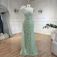 Sage Green One-Shoulder Mermaid Evening Gown - Luxurious Dubai Arabic Design with Pearls Sage Green Wedding Dress For Bride, Green Dress With Pearls, Pastel Green Prom Dress, Arabic Fashion, Rich Style, Fantasy Outfits, Mermaid Evening Gown, Green Mermaid, Arabic Design