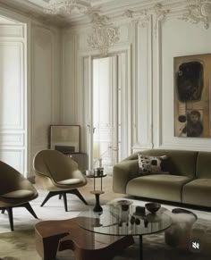 a living room filled with lots of furniture and walls covered in white paneled panels