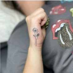 a woman with a flower tattoo on her left arm and the word love written in it