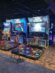 several video game machines lined up in a room