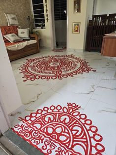 two red and white rugs sitting on top of a floor next to a doorway