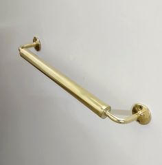 a gold colored handle on a white wall