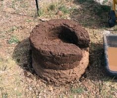 a large mound of dirt next to a wheelbarrow