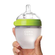 a person holding a baby bottle in their hand