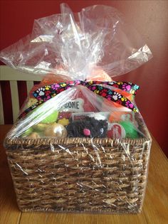 a basket filled with lots of treats on top of a wooden table