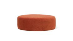 an orange ottoman sitting on top of a white floor