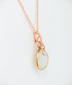 Experience the enchantment of our stunning Rose gold moonstone and diamond necklace! Let yourself be captivated by its radiant beauty and delicate charm. This elegant mystic white moonstone necklace, adorned with a solitary 2.5mm diamond drop set in 14K rose gold, a hand textured bail, and a luminous glimmering teardrop-shaped moonstone encased in a luxurious rose gold vermeil bezel. Indulge in the pure elegance and charm of a rose gold moonstone and diamond necklace. Delicate and dainty, this beautiful rose gold necklace adds a subtle shimmer, feminine charm and timeless beauty to your look. This one-of-a-kind piece is the perfect gift for yourself or someone special.. Feel the magic and radiance every time you wear it. Order now and bring a touch of dreamy romance into your everyday life Elegant Moonstone Necklace With Delicate Chain, Elegant Moonstone Necklace With Moon Charm, Elegant White Charm Necklace With Moon Charm, Elegant White Moon Charm Necklace, Elegant Teardrop Pendant Necklace With Moon Charm, Dreamy Romance, Diamond Charm Necklace, Radiant Beauty, Pure Elegance