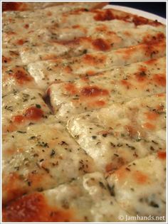 a close up of a pizza with cheese and sauce