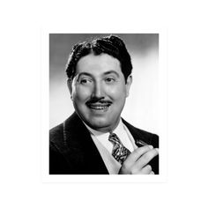 a black and white photo of a man in a suit with a moustache on his face