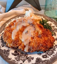 a plate topped with meat covered in gravy