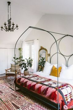 a bedroom with a canopy bed and rug on the floor