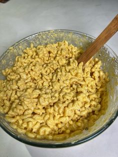 a glass bowl filled with macaroni and cheese