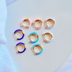 The cutest little huggie hoops that bring some pop of color to your ears! They're made with an long lasting enamel coating . .5" wide Sapphire blue, baby blue, baby pink, neon pink, white, and teal Gold-filled is the closest alternative to solid gold. Gold filled jewelry has a thick layer of solid gold bonded onto the base layer, usually brass or sterling silver. Compared to gold plated which uses a process of electroplating that quickly dips your jewelry in gold, resulting in a miniscule layer Gold Bond, Teal Orange, Pink Neon, Teal And Gold, Blue Baby, Enamel Jewelry, Sapphire Blue, Gold Filled Jewelry, White Sapphire