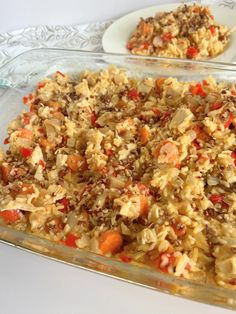 a casserole dish with carrots, rice and other food items in it