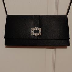 Black Satin Style Bag With Snap Closure. Rhinestone Style Emblem On Front. Black Cord Shoulder Strap. Single Compartment. No Label. Nwot Formal Black Bags With Rhinestones, Classic Shoulder Bag With Silver-tone Hardware For Party, Elegant Black Clutch With Silver-tone Hardware, Classic Party Bags With Silver-tone Hardware, Elegant Wedding Evening Bag With Silver-tone Hardware, Classic Silver Shoulder Bag For Evening, Formal Evening Bag With Rhinestones, Elegant Black Evening Bag With Rhinestones, Black Evening Bag With Silver-tone Hardware For Party