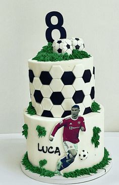 a three tiered cake with an image of a soccer player on the front and number 8 on the back