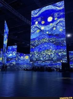 the starry night painting is projected in an open space