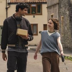 a man and woman walking down the street