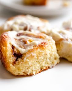 cinnamon rolls with icing sitting on a plate