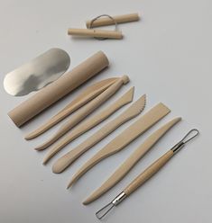 several different types of kitchen utensils and spoons on a white table top