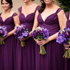 the bridesmaids are wearing purple dresses and holding bouquets in their hands together