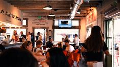 a group of people sitting at tables in a restaurant