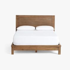 a bed with white sheets and pillows on it's headboard, against a white background