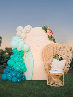 a chair and some balloons in the grass