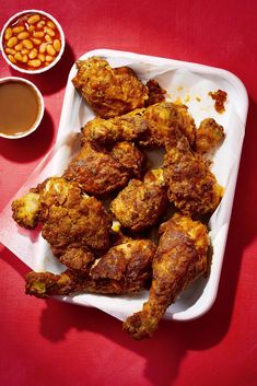 fried chicken and beans on a red table