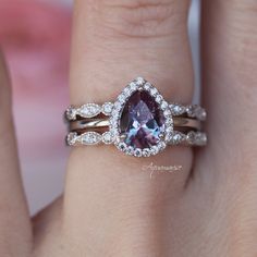 Beautiful Teardrop Alexandrite Ring ►Base Metal: Sterling Silver (S925) ►Plating: 14K Rose Gold ►Accented with simulated diamonds (CZ) ►Can be paired with one or two bands of your choice (select option from the drop-down menu). Center Stone: Alexandrite Stone Cut: Pear Gem size: 8.0 x 6.0 mm Carat Weight: 1.25 ct. (approx.) Gemstone creation: 100% Genuine Lab-Grown Alexandrite Stone Origin: Russia Hardness: 8.5 (Mohs scale) ►The color of Alexandrite changes under different lighting conditions. I Classic Teardrop Gemstone Rings, Exquisite Amethyst Center Stone Wedding Ring, Exquisite Diamond Amethyst Wedding Ring, Exquisite Diamond Amethyst Ring For Weddings, Elegant Stackable Rings With Accent Stones For Formal Events, Elegant Stackable Rings With Accent Stones For Formal Occasions, Elegant Teardrop Diamond Ring With Accent Stones, Elegant Stackable Diamond Rings With Accent Stones, Elegant Diamond Stackable Rings With Accent Stones