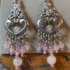 Pink Chandelier Drop Earrings For Gift, Pink Heart Earrings For Pierced Ears, Pink Metal Heart Earrings For Pierced Ears, Pink Chandelier Earrings For Gift, Pink Dangle Chandelier Earrings As Gift, Pink Metal Jewelry With Dangling Beads, Elegant Pink Nickel-free Chandelier Earrings, Elegant Nickel-free Pink Chandelier Earrings, Pink Teardrop Chandelier Earrings For Gift