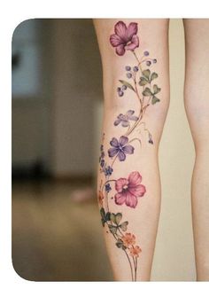 a woman's legs with flowers on them