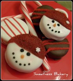 chocolate covered candies decorated like snowmen with candy canes