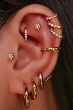 three different types of ear piercings on top of each other