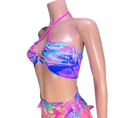 Our electrifying X-String Rave Bikini Top, where vibrant colors and futuristic design collide to create the ultimate statement piece for your next rave or poolside party! Crafted from high-quality rainbow vapor print spandex, this bikini top is guaranteed to turn heads and ignite the dance floor with its eye-catching style.Fully lined and meticulously constructed with elastic on both the top and bottom, this bikini top offers a secure and comfortable fit that stays in place no matter how wild th Rave Stretch Swimwear For Music Festival, Pink Rave Swimwear For Party, Fitted Rave Swimwear For Music Festival, Fitted Rave Swimwear For Poolside, Rave Style Swimwear For Poolside, Rave Swimwear With Stretch For Party, Stretch Rave Swimwear For Party, Rave Style Stretch Swimwear For Party, Rave Party Swimwear For Beach Season