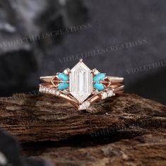 a white diamond ring with turquoise stones on top