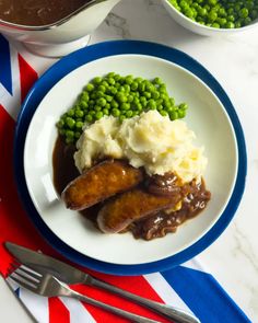 a plate with meat, mashed potatoes and peas