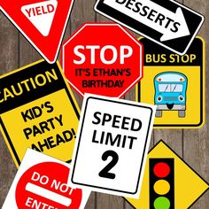 various traffic signs on wooden planks with one saying stop it's birthday, and the other saying speed limit