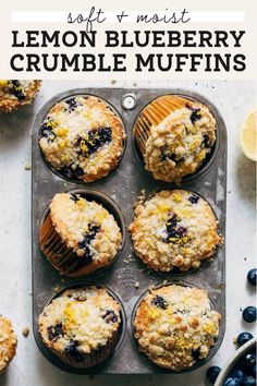 blueberry muffins in a muffin tin next to fresh blueberries