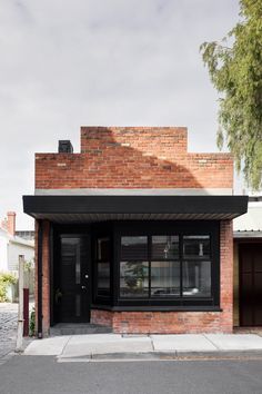 a brick building with black doors and windows